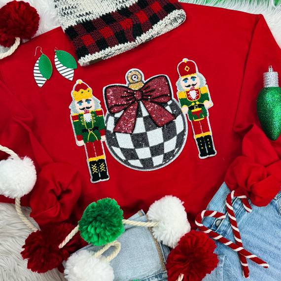 Nutcrackers Black and White Checkered Bulb Sequin Patch, Christmas embroidered patch featuring a festive black and white checkered ornament with a red bow, flanked by two nutcracker figures, perfect for holiday decor and craft embellishments.