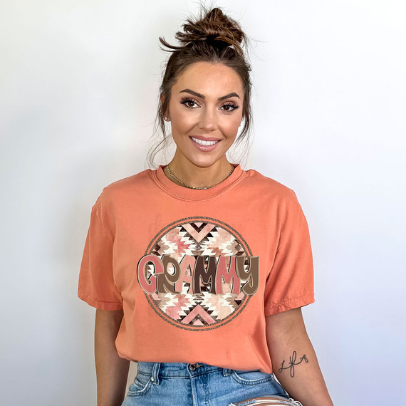 Grammy Aztec DTF Heat Transfer, a decorative heat transfer with an Aztec pattern and the word 'GRAMMY' in bold letters on a woman's t-shirt.