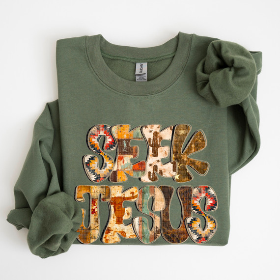 Seek Jesus DTF Heat Transfer, colorful patterned text design on an olive green sweatshirt.
