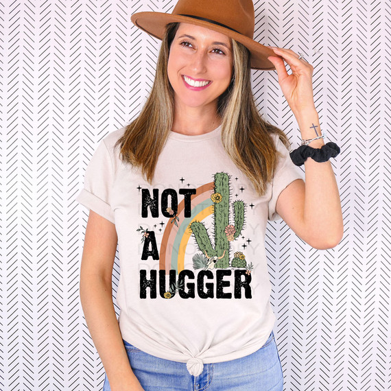 Not A Hugger Cactus DTF Heat Transfer, humorous graphic heat transfer with cactus and rainbow design on a woman's t-shirt.