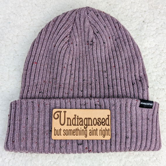 Undiagnosed But Something Aint Right Leather Hat Patch, purple knitted beanie hat with a leather patch featuring the text