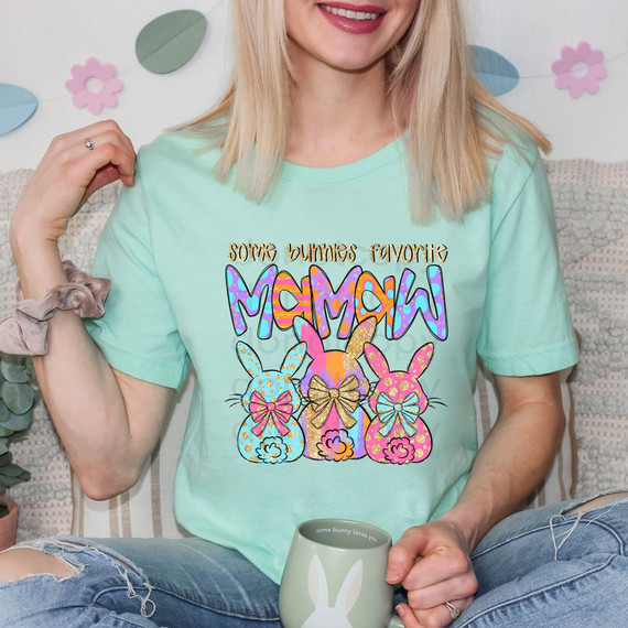 Some Bunnies Favorite Mamaw DTF Heat Transfer, colorful Easter-themed bunny graphic on a woman's mint green t-shirt.
