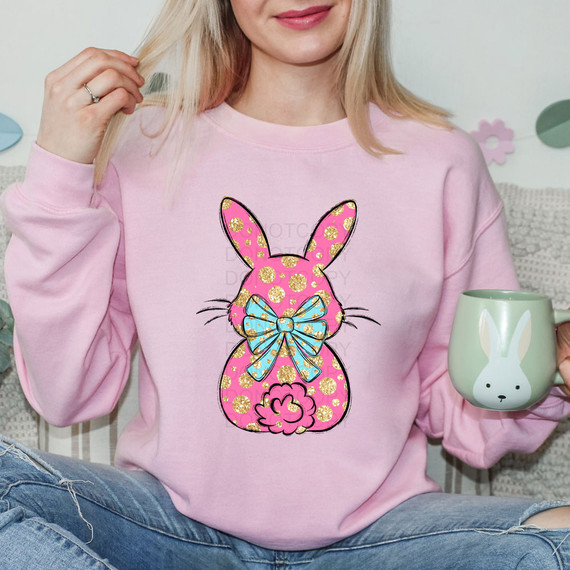 Pink Faux Glitter Polka Dot Bunny DTF Heat Transfer, decorated bunny design on a pink sweatshirt with a blue bow.