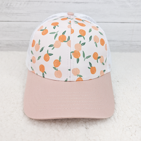 Peach Patterned Trucker Style Hat, a stylish cap with a peach fruit pattern on the front panel and a pale pink curved brim.