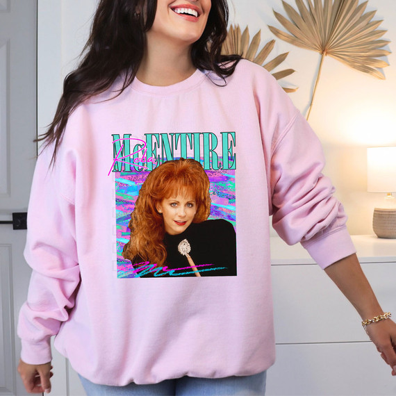 Reba DTF Heat Transfer, colorful graphic design featuring Reba McEntire on a light pink sweatshirt.
