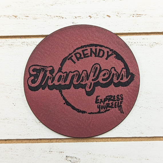 Custom Faux Leather Hat Patch - Circle, round faux leather patch with black embroidered text 'Trendy' and 'Express Yourself' on a red background.