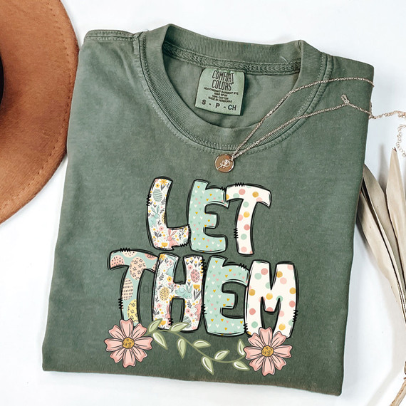 Let Them Easter Pattern DTF Heat Transfer, floral-themed colorful letters spelling out 'Let Them' on a green T-shirt.