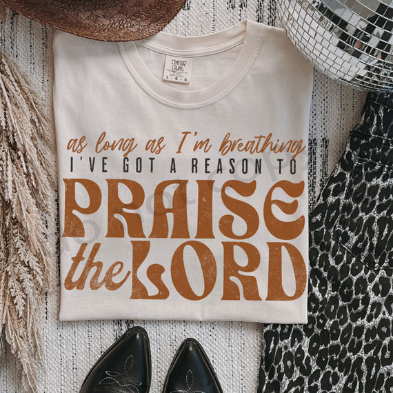 As Long As I'm Breathing I've Got A Reason To Praise The Lord DTF Heat Transfer T-shirt, white t-shirt with inspirational scripture design in brown and black.