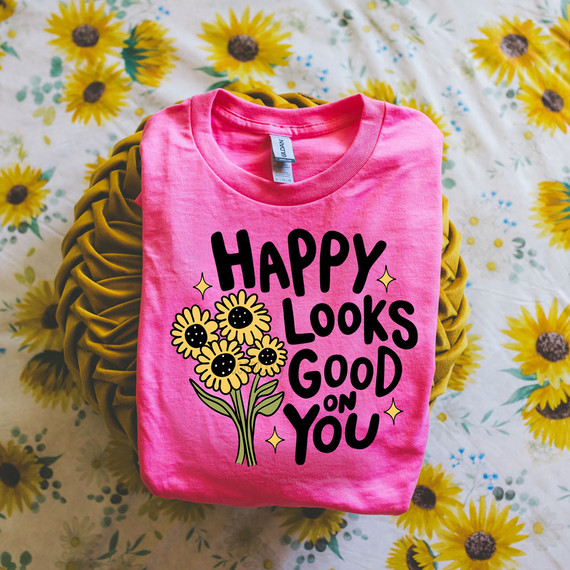 Happy Looks Good On You Sunflowers DTF Heat Transfer, pink T-shirt with sunflower graphic and cartoon text design.