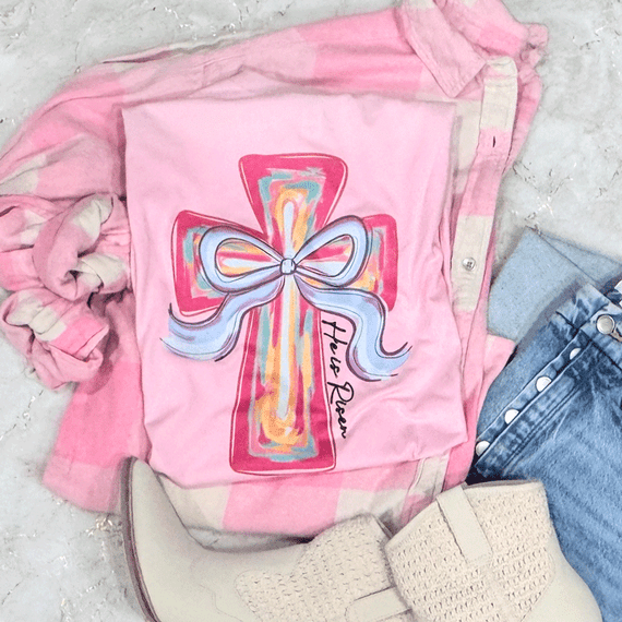 He Is Risen Colorful Cross CLEAR Screen Print Heat Transfer, vibrant cross with a bow, on pink fabric, Christian religious design.