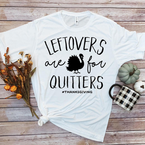Leftovers are for Quitters Turkey Thanksgiving Sublimation Transfer T-shirt with turkey graphic, placed on a wooden background with decorative pumpkins, a mug, and dried flowers.