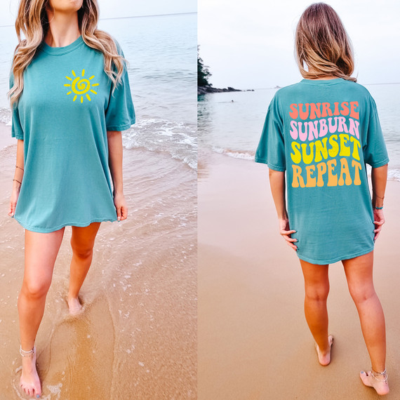 Sunrise Sunburn Sunset Repeat SET DTF Heat Transfer, woman wearing a teal T-shirt with a yellow sun graphic on the front and colorful text design on the back standing on the beach.