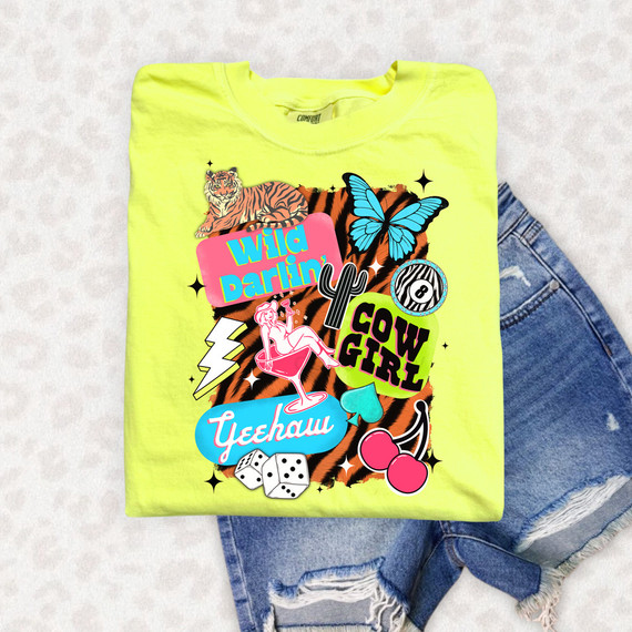 Wild Darlin’ Cowgirl Collage DTF Heat Transfer, vibrant neon yellow t-shirt with colorful cowgirl-themed graphics and text, featuring a tiger, butterfly, lightning bolt, pool girl, dice, and cherries design.