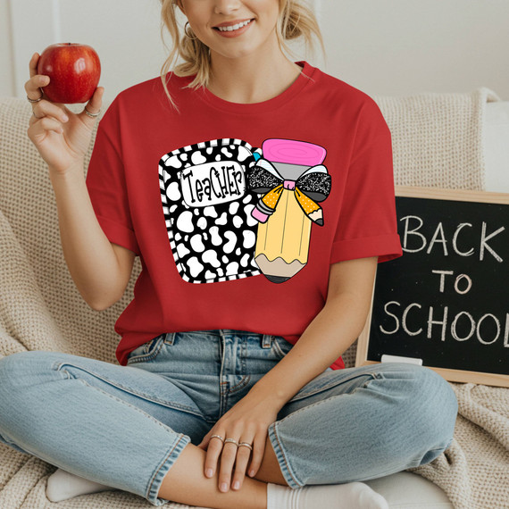 Retro Teacher Notebook With Pencil DTF Heat Transfer, a colorful and playful design featuring a cow-print notebook labeled 'Teacher' and a large, decorated pencil with a bow.