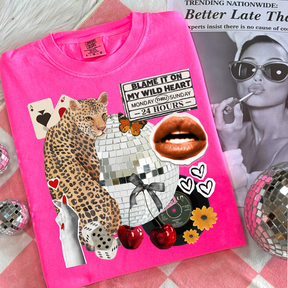Blame It On My Wild Heart Collage DTF Heat Transfer on a bright pink T-shirt with various decorative stickers including a leopard, cherries, lips, dice, a butterfly, hearts, a vinyl record, and a sign with text, displayed with a black and white woman photo in the background.
