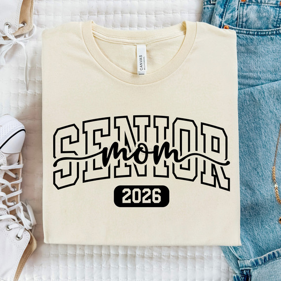 Senior Mom 2026 Coquette BLACK DTF Heat Transfer, cream-colored t-shirt with 'Senior Mom 2026' printed in bold black letters and 'mom' written in cursive, perfect for celebrating graduating mothers.
