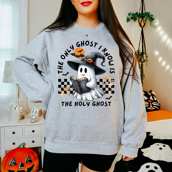The Only Ghost I Know Is The Holy Ghost DTF Heat Transfer, cartoon ghost wearing a witch hat reading a book with Halloween-themed background.
