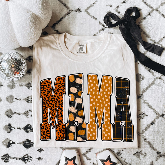 Mama Fall Patterned DTF Heat Transfer, decorative fall-themed cutout designs on a white T-shirt with a black bow, surrounded by festive decorations.