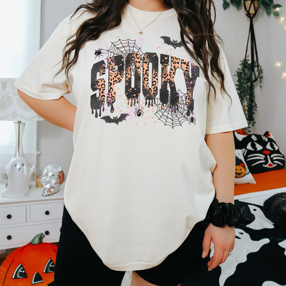 Spooky Leopard Web DTF Heat Transfer, Halloween-themed t-shirt with spooky leopard print, bats, spiders, and spiderwebs in black, orange, and purple colors.