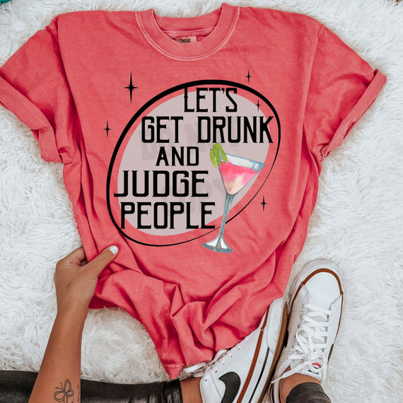 Let's Get Drunk And Judge People DTF Heat Transfer, pink T-shirt with a cocktail glass graphic and bold black text.