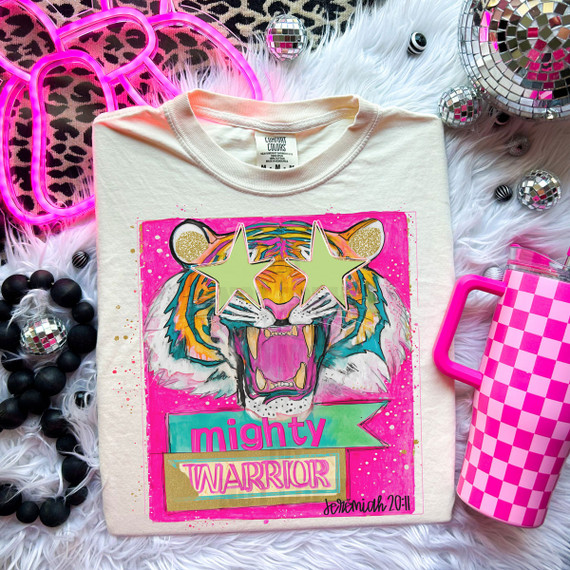 Mighty Warrior Tiger DTF Heat Transfer, colorful tiger graphic with star-shaped glasses on a white T-shirt, with neon pink and decorative accessories around it.