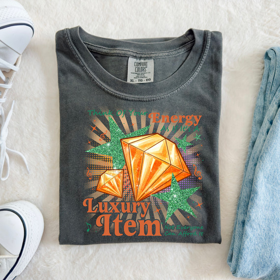 T-shirt, Think Of Your Energy As If It's A Luxury Item Not Everyone Can Afford It DTF Heat Transfer design featuring sparkling green stars and orange gemstones.