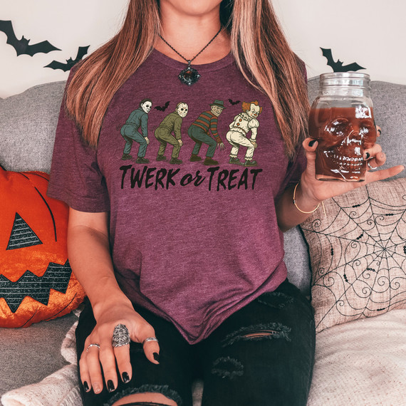 Twerk or Treat DTF Heat Transfer, Halloween-themed graphic T-shirt featuring characters in costumes on a maroon shirt.