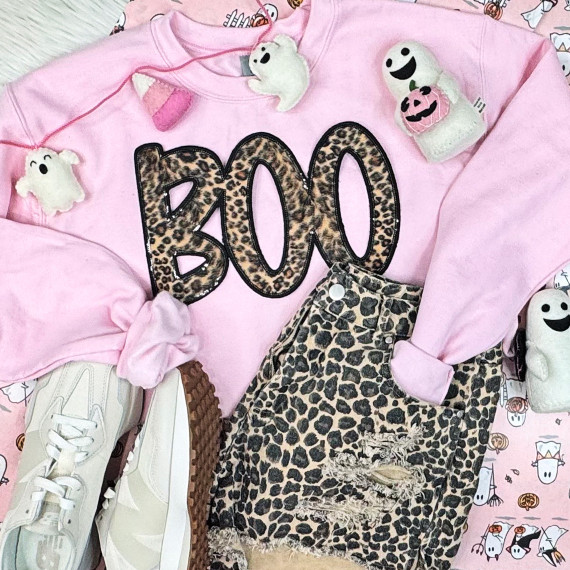 Leopard BOO Sequin Patch, pink sweatshirt with leopard print 'BOO' lettering and various Halloween plush toys and distressed leopard print jeans.