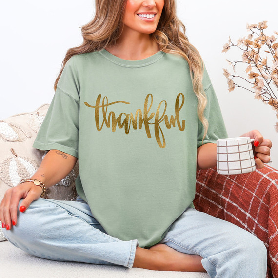 Thankful Faux Gold Metallic DTF Heat Transfer, a gold metallic design on a light green T-shirt.