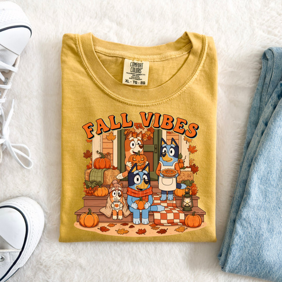 Fall Vibes Blue Family DTF Heat Transfer, colorful illustration of dogs celebrating fall with pumpkins, autumn leaves, and a cozy porch scene on a yellow T-shirt.