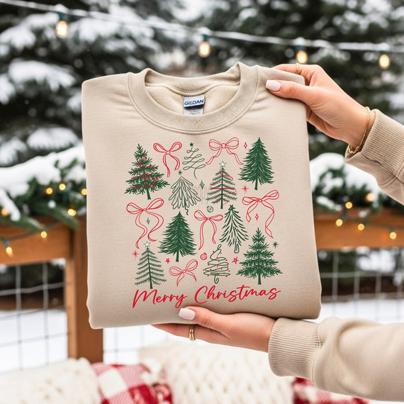 Merry Christmas Bows & Trees DTF Heat Transfer, Christmas-themed design on a beige sweatshirt with illustrations of various Christmas trees and red bows for holiday decoration.