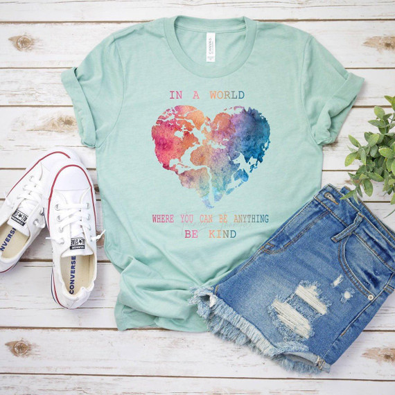 In A World Where You Can Be Anything Be Kind Screen Print Heat Transfer, T-shirt with colorful world map in the shape of a heart and positive message.
