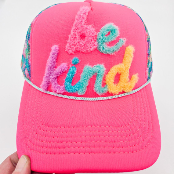 Be Kind Fluffy HAT Patch, colorful fuzzy embroidery spelling 'be kind' on a pink hat.