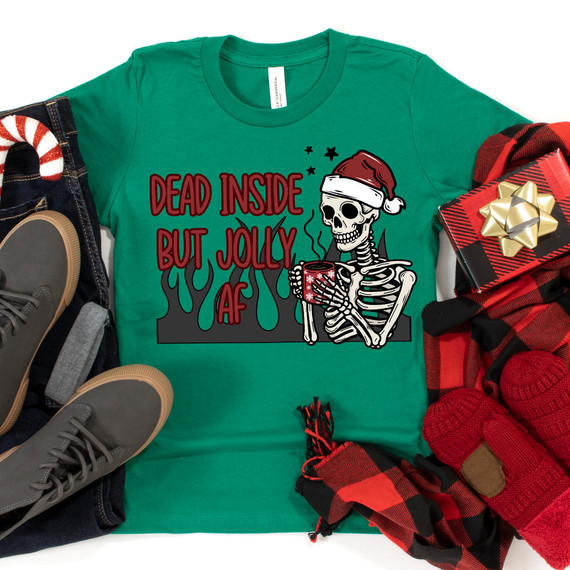 Dead Inside But Jolly AF Skeleton DTF Heat Transfer, green t-shirt with skeleton wearing Santa hat holding a festive mug, surrounded by holiday accessories.