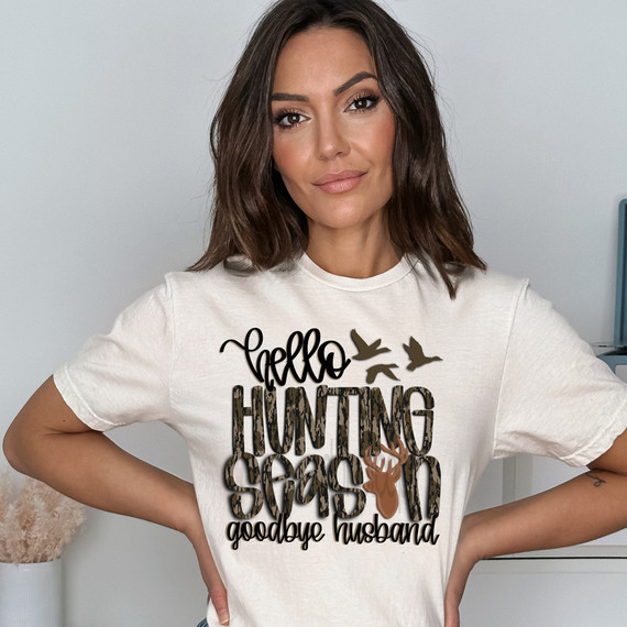 Hello Hunting Season, Goodbye Husband Camo DTF Heat Transfer, woman wearing white t-shirt with hunting-themed design including birds, a deer head silhouette, and cursive text.