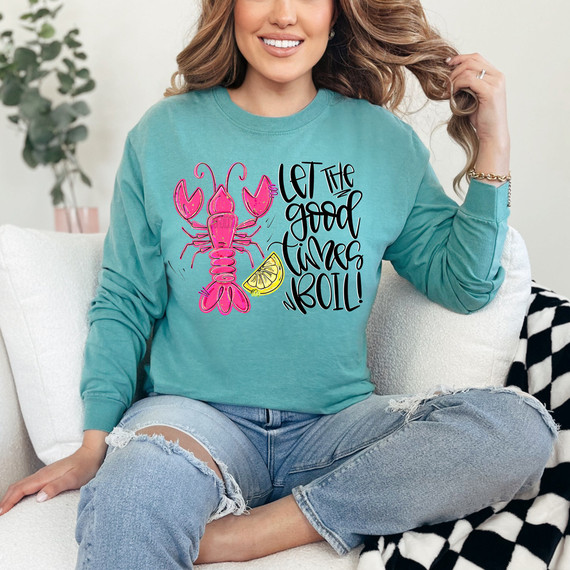 Let The Good Times Boil Crawfish DTF Heat Transfer, colorful design of a pink crawfish with a lemon slice on a teal sweatshirt.
