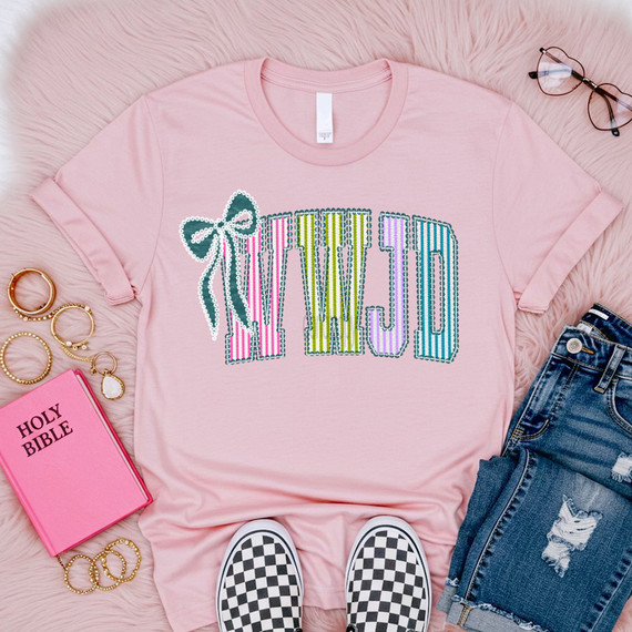 WWJD Seersucker Bow DTF Heat Transfer, colorful seersucker bow design on a pink t-shirt.