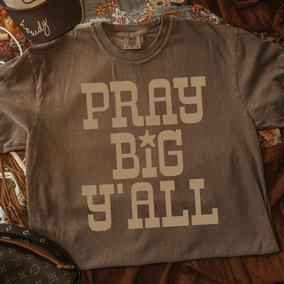 Pray Big Y'all DTF Heat Transfer, a brown T-shirt with the phrase 'Pray Big Y'all' printed in large, bold letters.