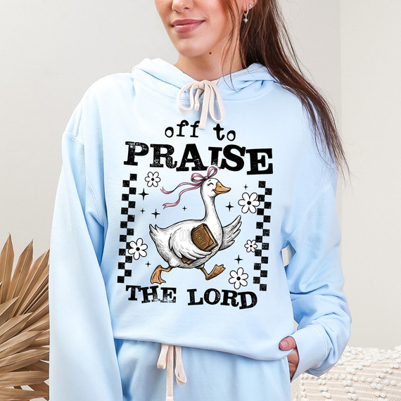 Off To Praise The Lord Goose DTF Heat Transfer, a humorous and colorful design featuring a cartoon goose with a Bible and flowers on a light blue hoodie.