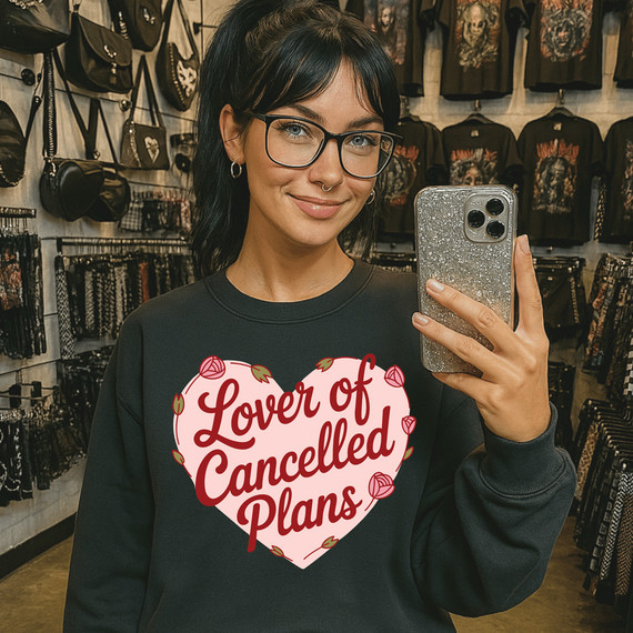 Lover Of Cancelled Plans Heart DTF Heat Transfer, woman taking a selfie wearing a sweatshirt with the phrase Lover Of Cancelled Plans inside a heart design.