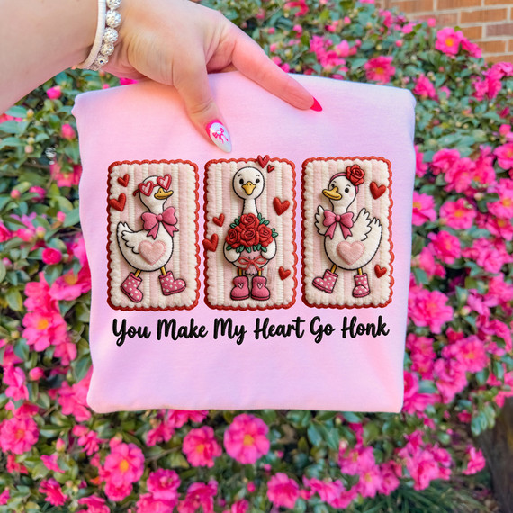 Faux Yarn You Make My Heart Go Honk DTF Heat Transfer, embroidered patch design featuring three swan characters with hearts and boots on a pink fabric background.
