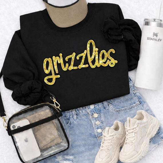Grizzlies Gold Sequins Patch – School Spirit Appliqué, the patch features the word 'gizzlies' in gold sequins on a black sweatshirt.