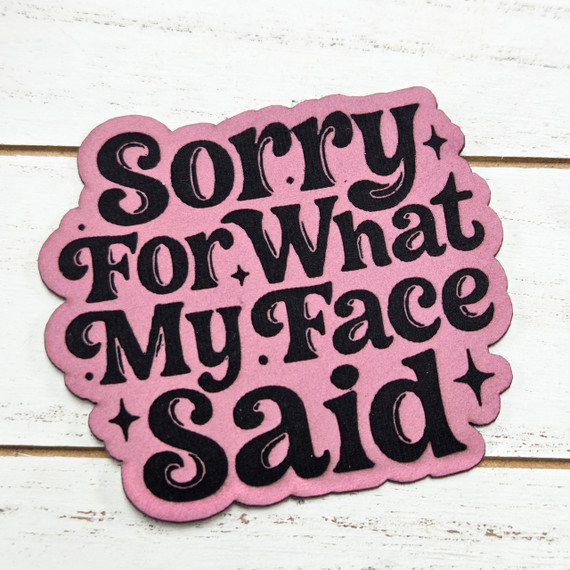 Sorry For What My Face Said FAUX Leather Patch, pink fabric patch with black embroidered text and decorative stars.