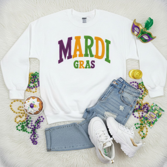 Fluffy Mardi Gras Letter Patch – Purple, Green & Gold, colorful fleece letter patches spelling 'MARDI GRAS' on a white sweatshirt with Mardi Gras beads, mask, gold coins, and festive decorations.