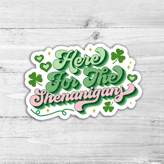 Here for the Shenanigans Die Cut Sticker, St. Patrick's Day themed sticker with green and pink lettering, shamrocks, hearts, and gold sparkles.