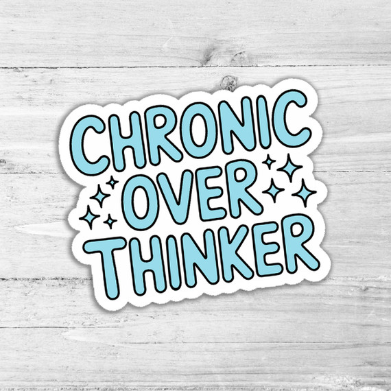 Chronic Overthinker Die Cut Sticker, a cute and colorful sticker with the words 'Chronic Overthinker' in bold, stylized blue letters, surrounded by small star accents on a light wooden background.