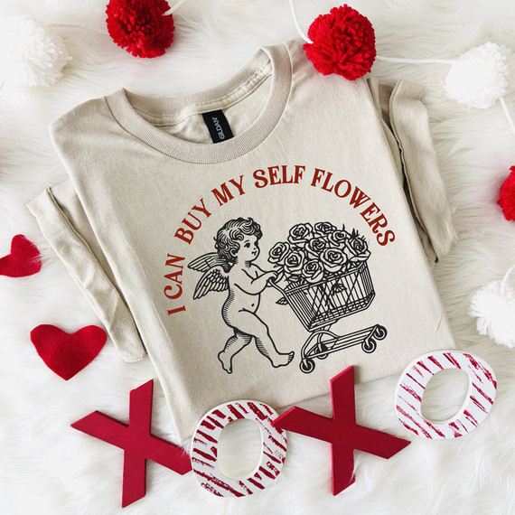 Buy Myself Flowers Cupid DTF Heat Transfer, a beige sweatshirt with a design of an angel pushing a shopping cart filled with roses, surrounded by Valentine hearts and XOXO decorations.