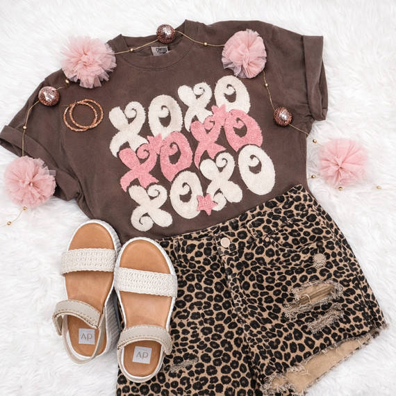 XOXO Fluffy Patch Muted Pinks T-shirt with pink fluffy patches and distressed leopard print shorts with sandals, fashion ensemble for casual wear.