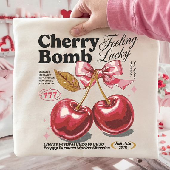 Cherry Bomb Feeling Lucky DTF Heat Transfer, product design featuring two cherries with a pink ribbon and decorative text.