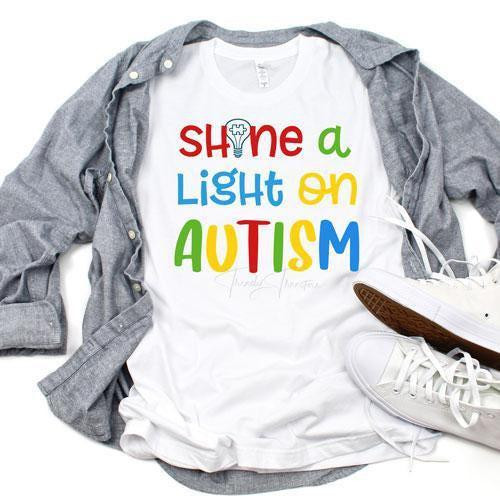 Autism Awareness Shine A Light Sublimation Transfer, t-shirt with colorful text design highlighting autism awareness.